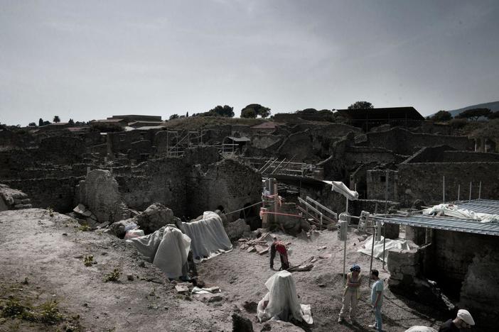 The archaeologists unearth a lavishly decorated fresco that looks like a pizza.