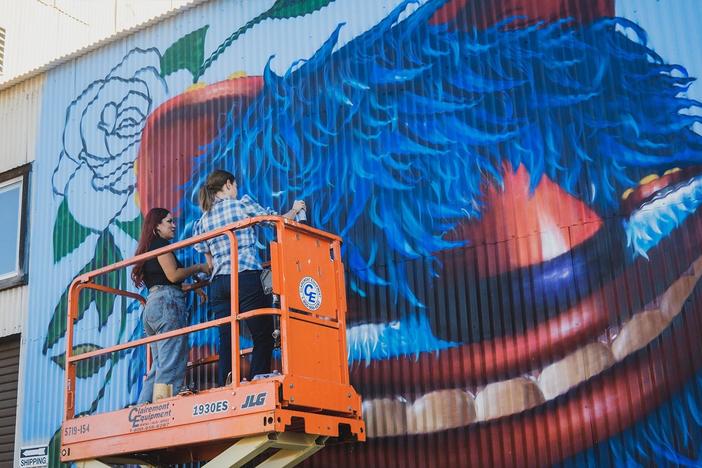 Pati paints a mural in San Diego with artist Michelle Guerrero, a.k.a. Mr. B Baby.