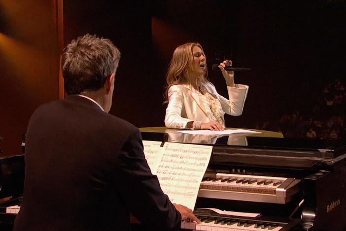 Celine Dion performs "Because You Loved Me" accompanied by David Foster on the piano.