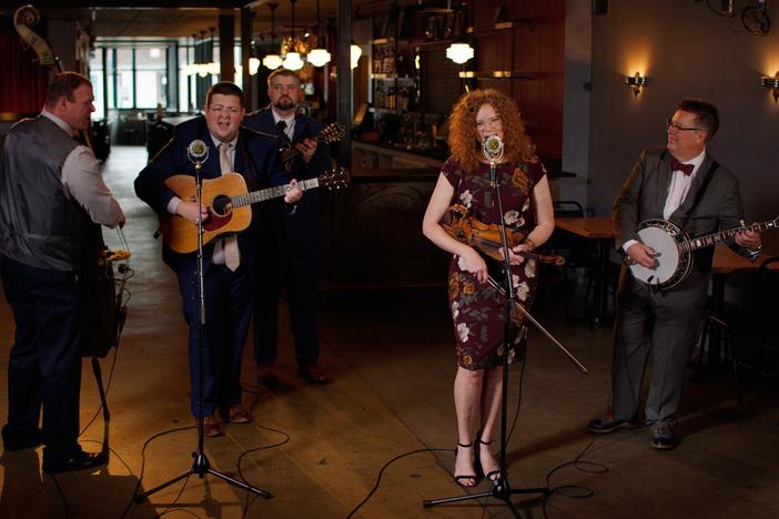 Host David Holt talks to Becky Buller, and her band plays a tune.