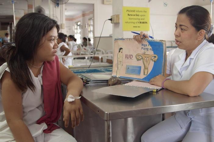 We see a counselor discussing birth control options with a couple of different mothers.