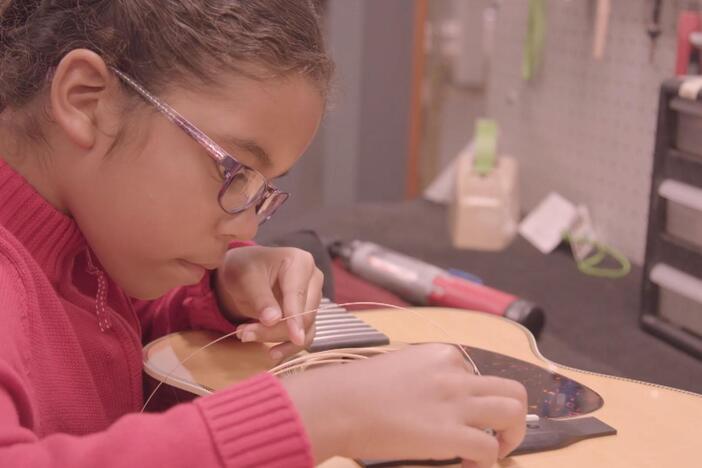 Real kid Camille visits a guitar factory where she learns how guitars are made.