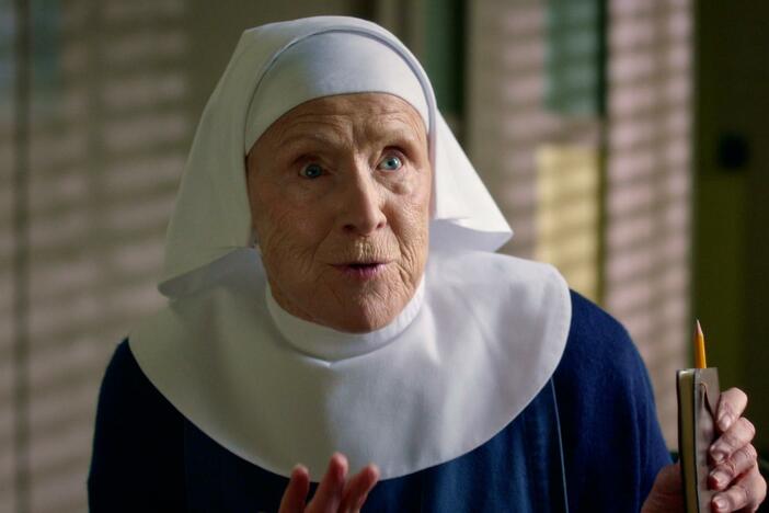 Sister Monica Joan turns to her peers for advice on her floral arrangement.