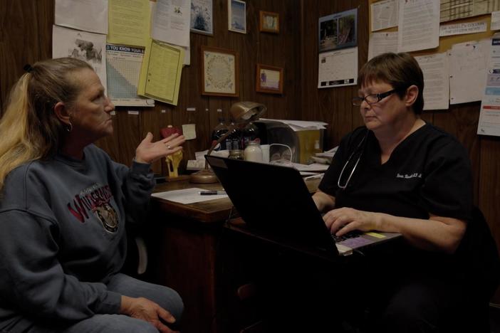 Dr. Kinsell, the only doctor in Clay County, Georgia, meets with a patient.