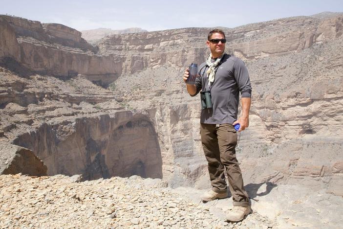 Steve Backshall and a team of experts prepare to descend a canyon in Oman.