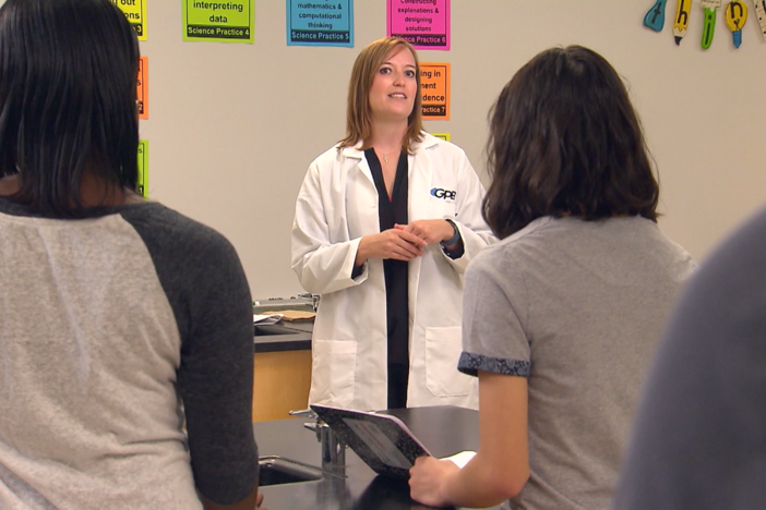 Teacher and students discuss their procedure to collect samples.