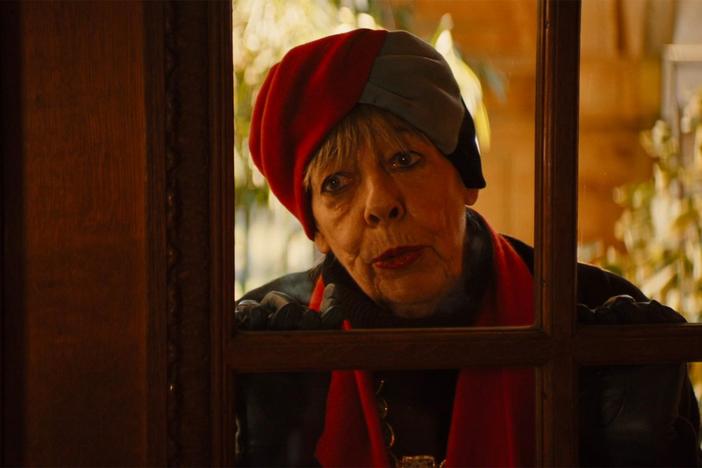 Professor T arranges the contents of his fridge and speaks to his mother.