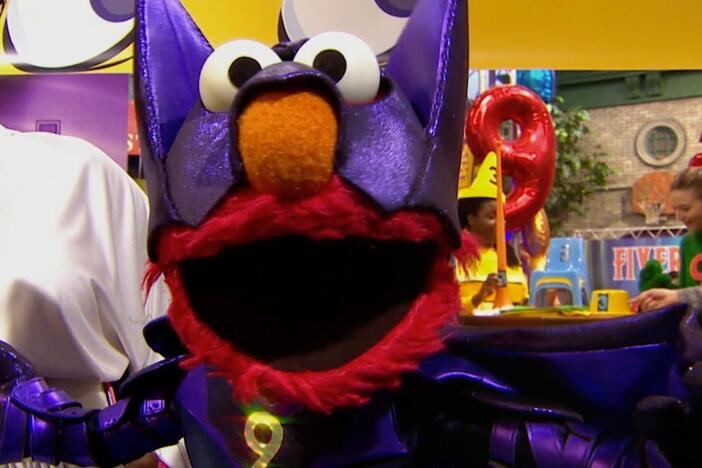 Elmo and Leela head to the number convention dressed as math superheroes.