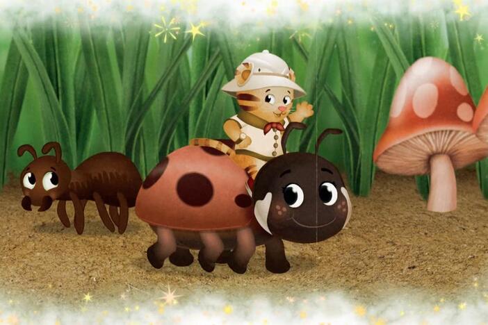 Daniel makes believe he is so little he can ride a ladybug through the grass.