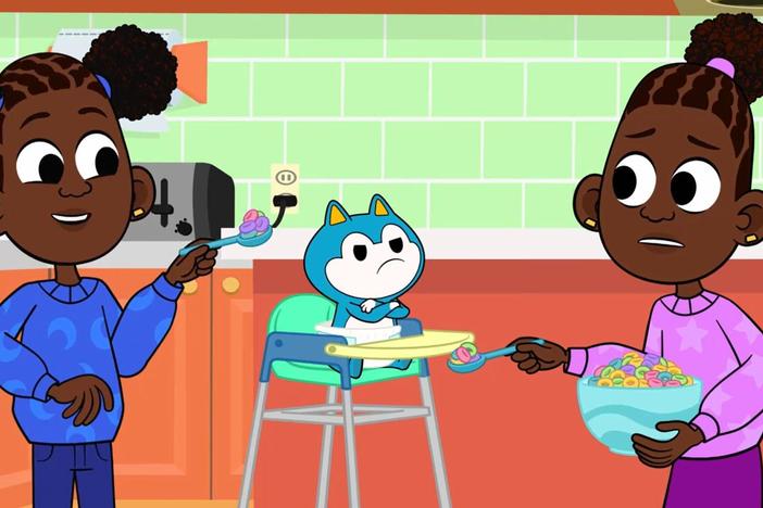Louisa and Liana get toddler Stu to eat his food.