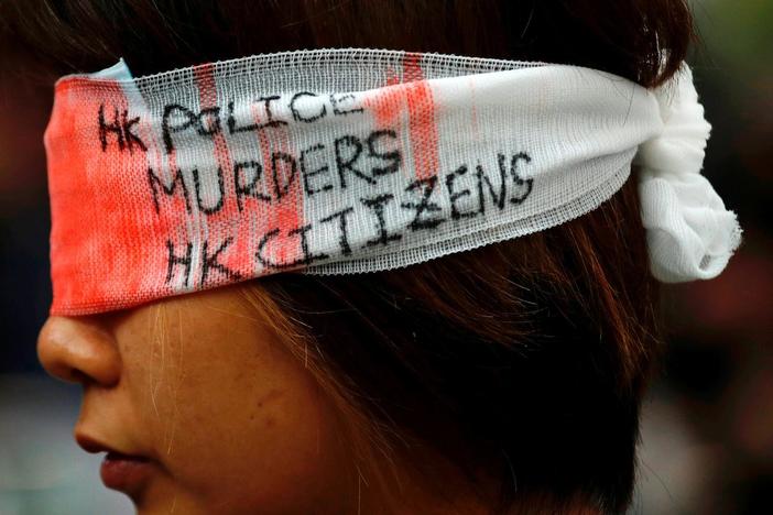 Amid paralyzing Hong Kong demonstrations, China threatens grave consequences