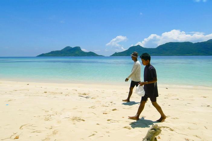 Fishermen Rajamil and Pidel Wali walk along the shores collecting plastic to use as lures.