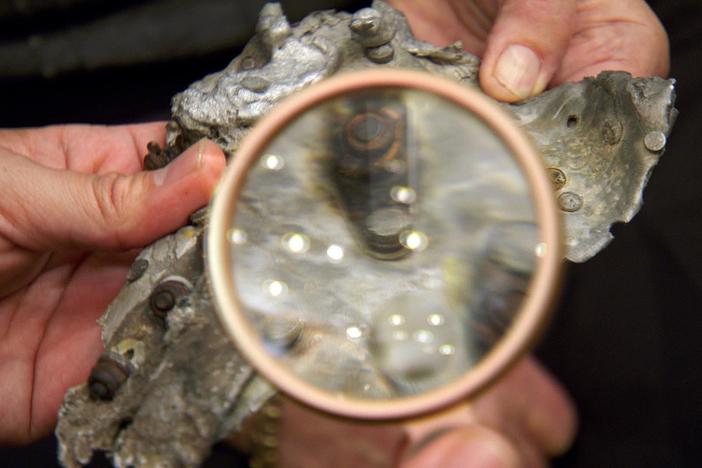 Eduardo links a chunk of molten metal to the B-25 Bomber that crashed into the Empire Stat