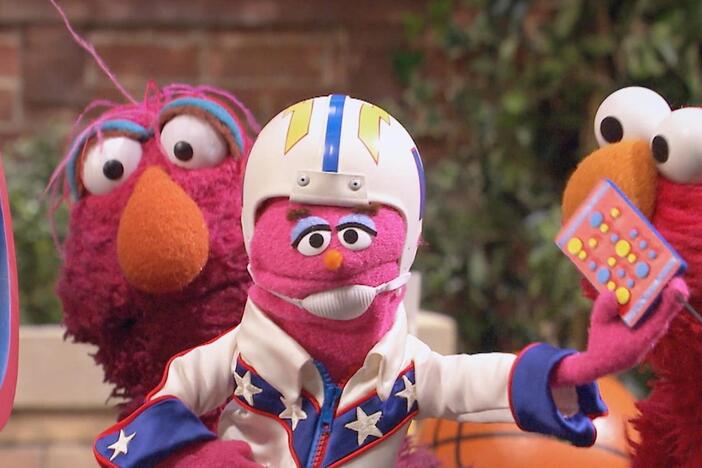 Elmo and friends help Hubert the Human Cannonball fly exactly 9 feet across Sesame Street!