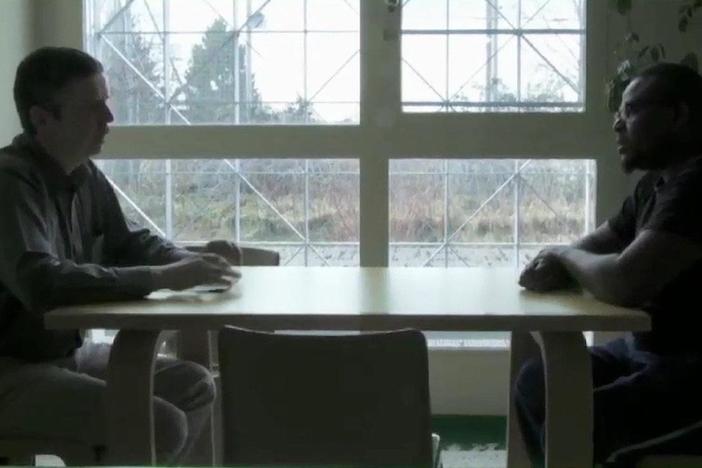 A man seeking asylum in Switzerland pleads his case to an official.