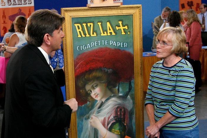  Philip Weiss appraises a Riz La tin advertisement sign, ca. 1910.