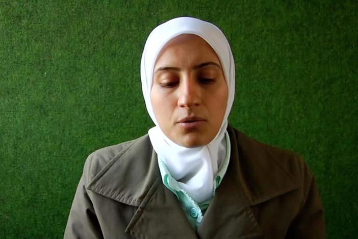 A woman recites a passage from the Qur'an.