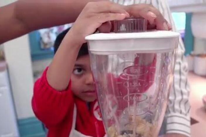 With help from Mom and Dad, Roshan makes his own banana swirl.
