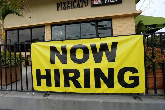 Job growth defies expectations but questions remain about overall health of economy