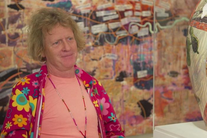 Grayson Perry shows Christiane his latest exhibition.