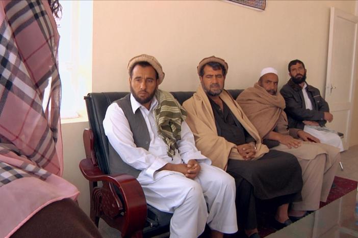 Razia meets with the mayor and town elders to discuss the benefits of the school.