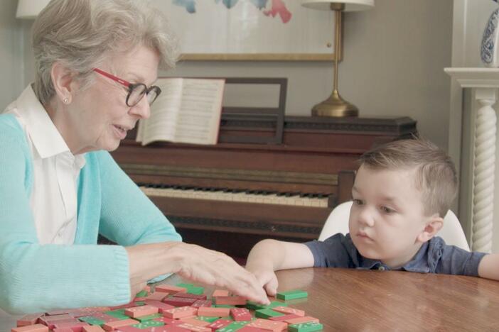 Real kid Benji feels mad while he plays dominos with his grandmother.