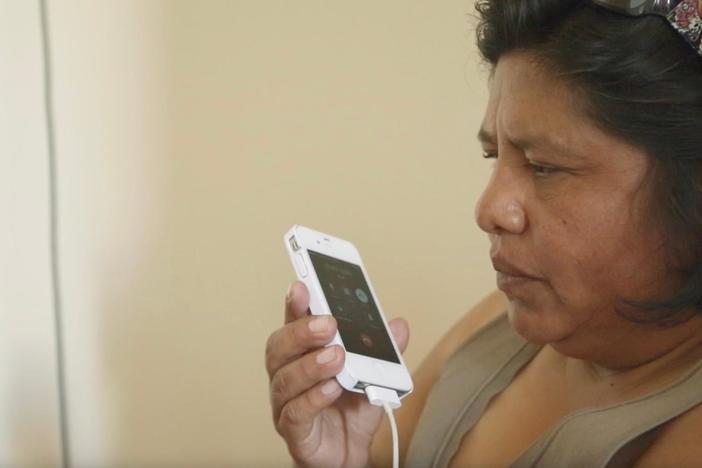 Feliza Ali Ramos speaks with a journalist about her experience as a person with a disability.
