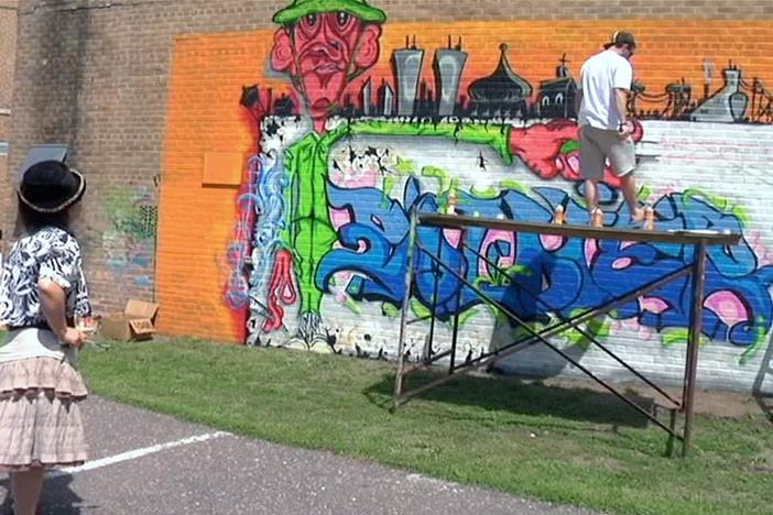 Dom completes a mural centered around his time in Afghanistan.