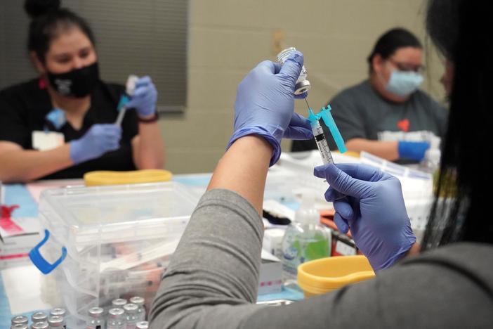 Slowing the spread of new COVID strains by changing public attitudes toward vaccinations