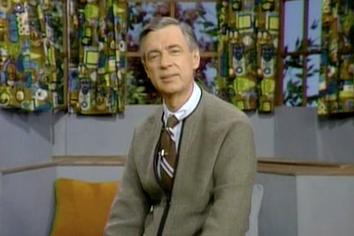 Behind the trolley, sneakers and puppets, Mister Rogers had a simple message.