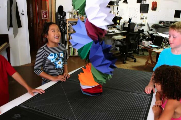 Watch students make a paper sculpture.