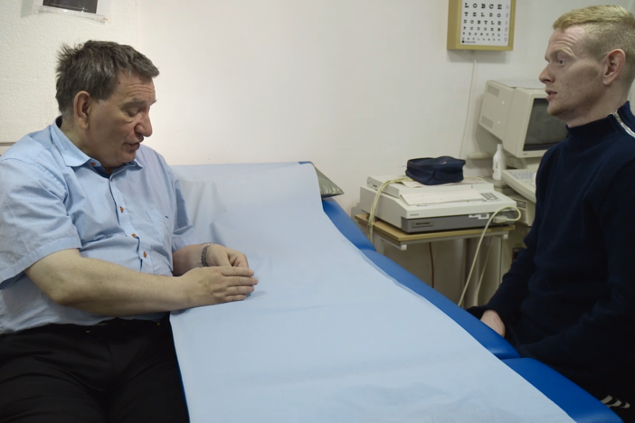 As he is examining a young local man Dr. Pál Weihe, Head of the Faroe Islands Department..
