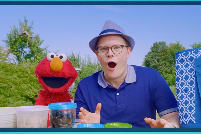 Mia, her dad Frank, and Elmo put together Mia’s family’s pasta salad for picnic day.