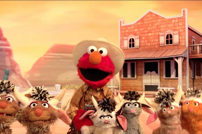 Cowboy Elmo counts his herd of kitty-cows.