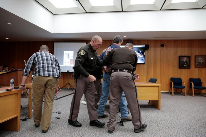 Chaos unfolded in a courtroom as a father of three sexual abuse victims tried to attack.