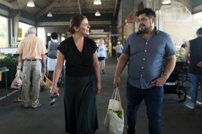 Oscar Diaz takes Vivian on a shopping tour at the North Carolina State Farmers Market.