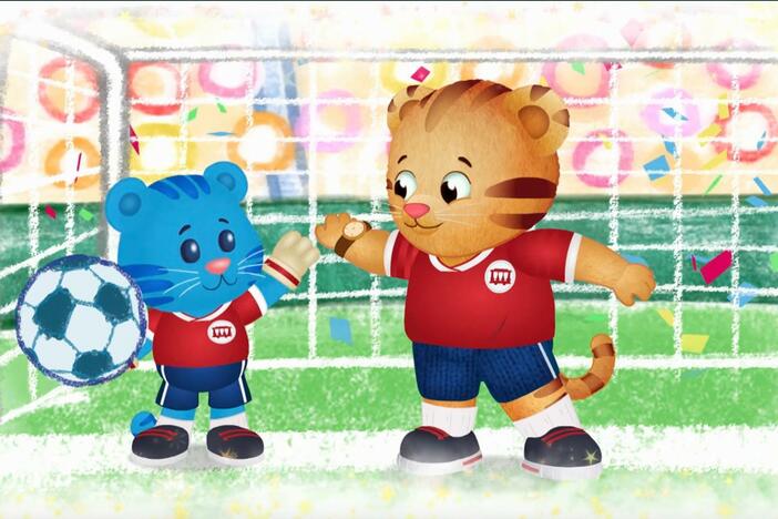 Daniel makes believe that he and Tigey are star soccer players.