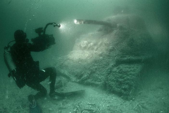 Dive teams, submersibles, and robots explore a massive underwater WWII archeological site.