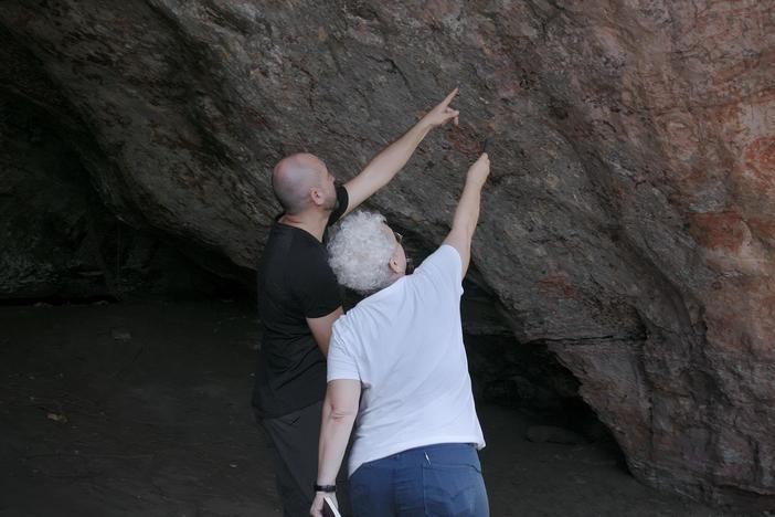 Archaeologist Edithe Pereira analyzes prehistoric wall paintings — careful to avoid wasps!