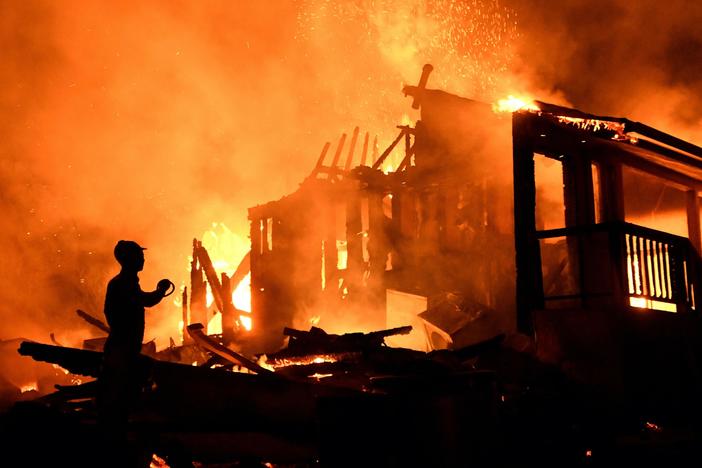 News Wrap: Dozens of wildfires still burning on West Coast