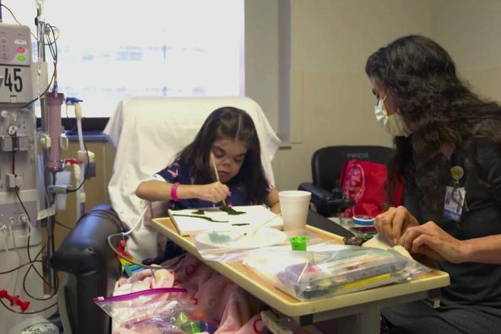 Artists work next to doctors to help with healing in hospitals