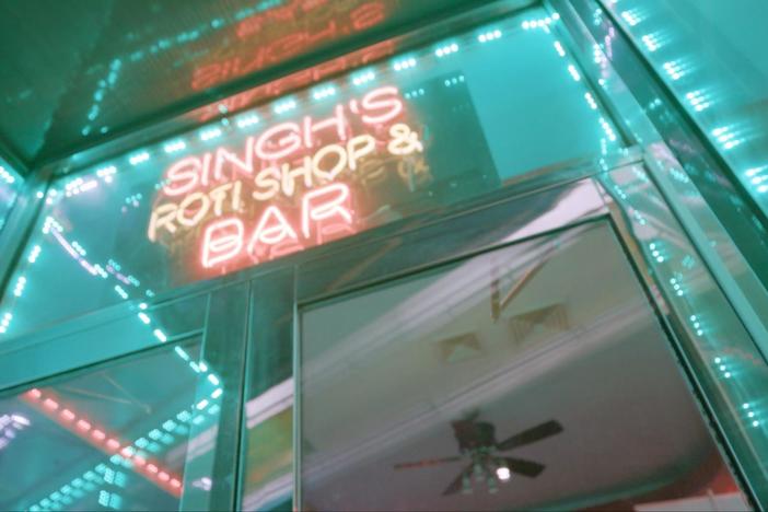 Marcus visits Singh’s Roti Shop, where Caribbean music and food collide.