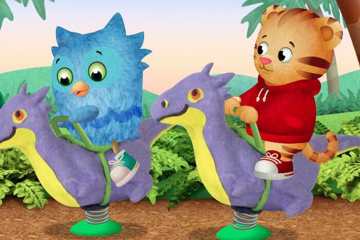 Daniel and O play on the rocking dinos, but Daniel rocks too fast.