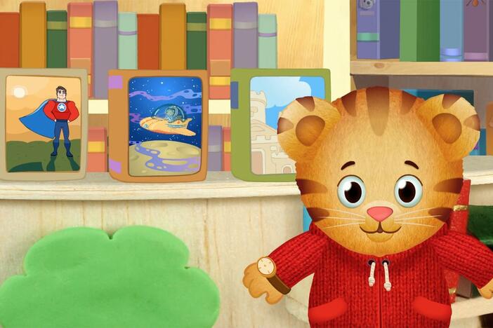 Daniel makes believe he's inside a storybook in the library. 