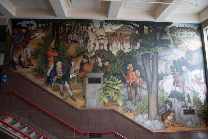 A mural exposes George Washington's ties to violence towards Native Americans and slaves.