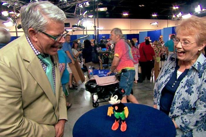 Marshall Martin appraises a Steiff Mickey Mouse toy from the 1930s.
