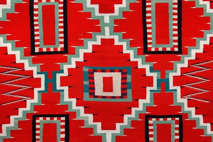 Douglas Diehl appraises an 1880s Navajo Germantown Blanket in Grand Rapids.