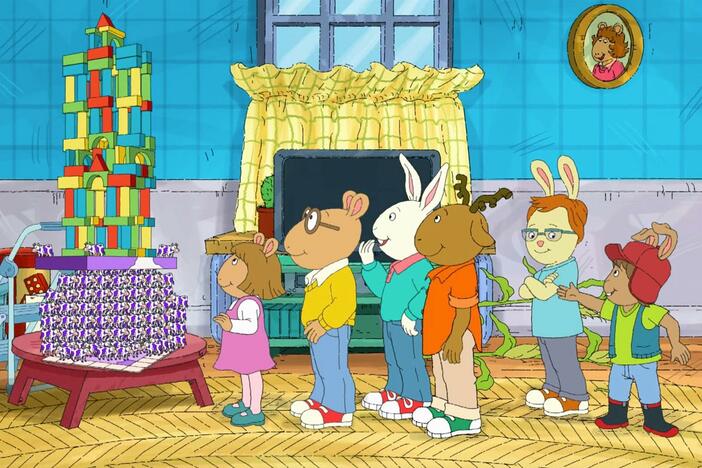 By helping build a tower and explain an episode, Carl resolves two disagreements at once.