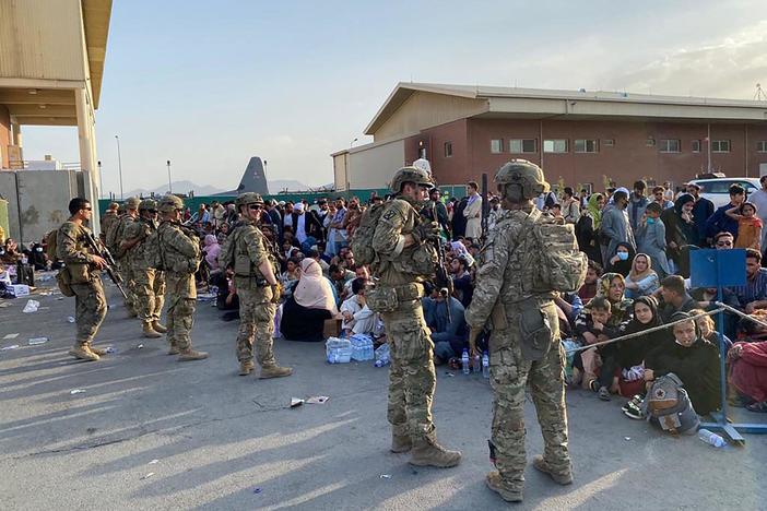 Thousands of Afghans can't access the airport. Those who can recall Taliban threats, abuse