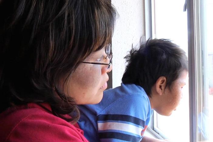 Michelle Evans Milota helps a family with XP protect their home from UV rays.